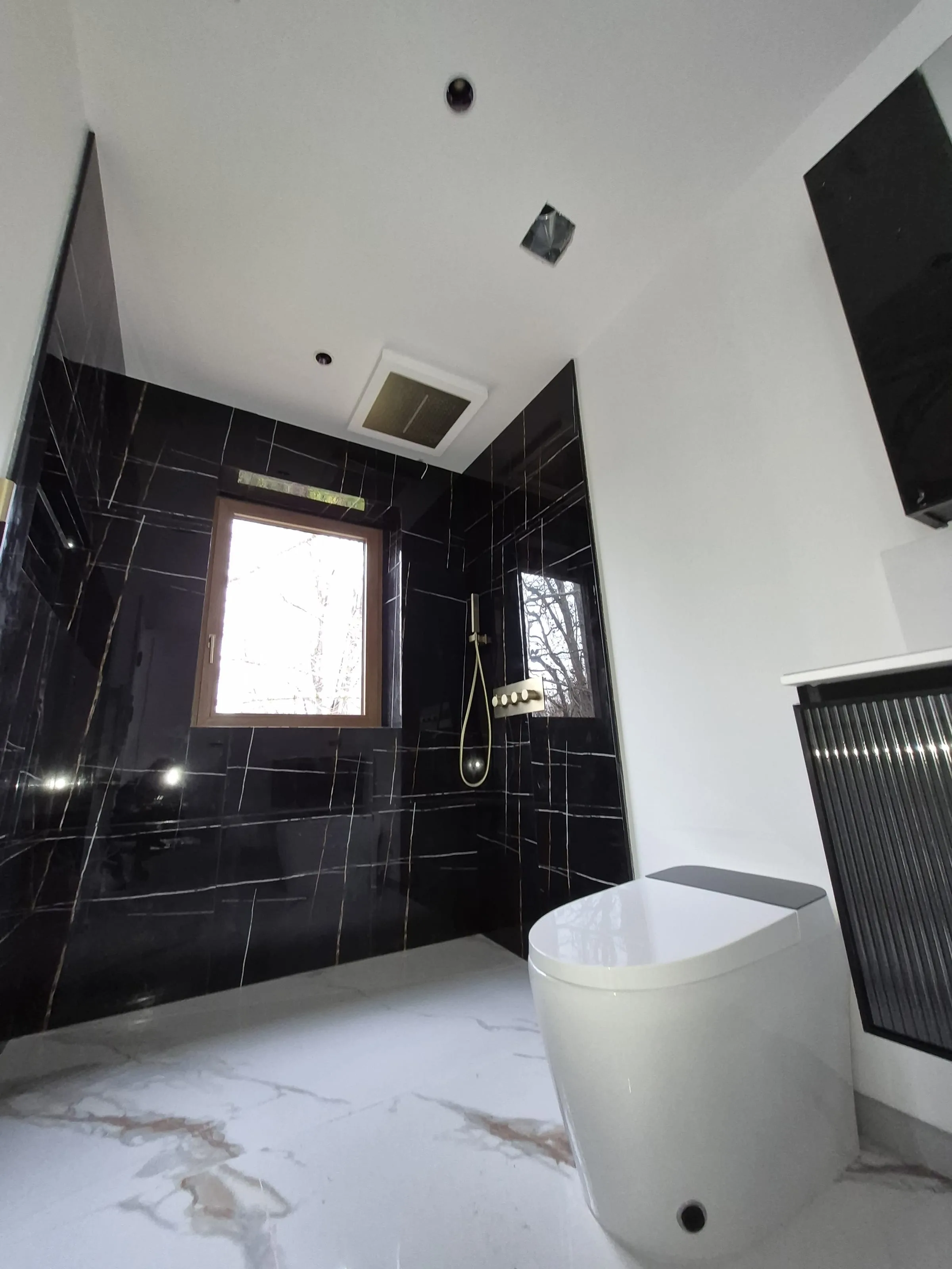 Brass fixtures against pre-sealed marble — reference for sealed-stone surface care